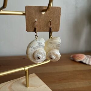 Natural pearlized white seashell dangle earrings with gold tone hooks